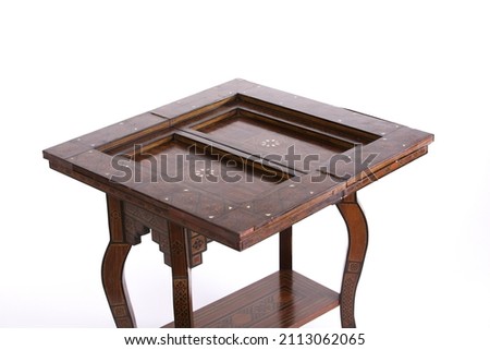 An antique fold out games table isolated on white