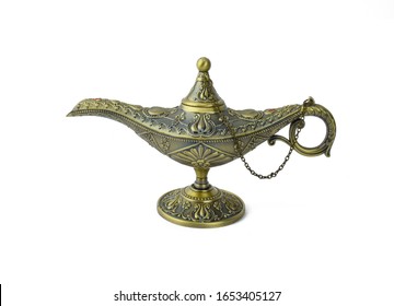 Antique Golden Colored Oil Lamp With Rust Displayed Over An Isolated White Background