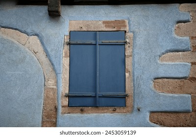 Antique half-timbered house window with wooden shutters in Riquewihr, Alsace France.  - Powered by Shutterstock