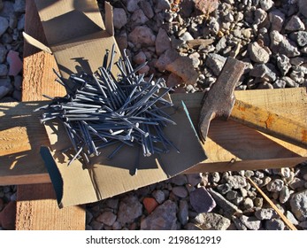 Antique Hammer And A Box Of Nails On A Construction Site. Selective Focus.