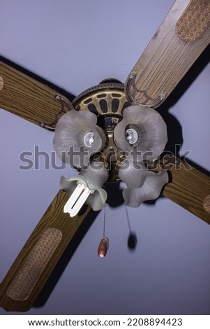 
an antique hanging fan that beautifies the interior of a room in the house.