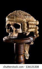Antique horsehair judge's wig on a creepy old skull