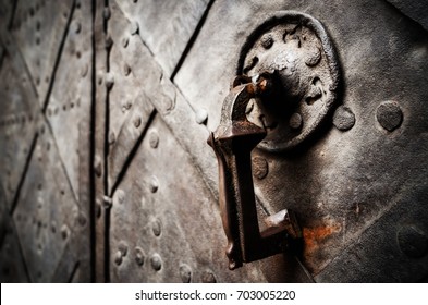 Antique Iron Knocker On A Medieval Castle Door