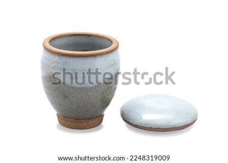 antique Japanese ceramic tea mug with lid. empty decorative ceramic cup isolated on white background. brown modern porcelain cup for drinking water. vintage handmade glaze for hot green tea 
