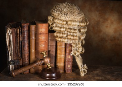 Antique judge's wig hanging on very old books