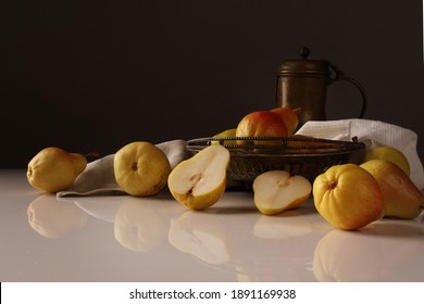 Antique jug, vase with pears on a white glossy table