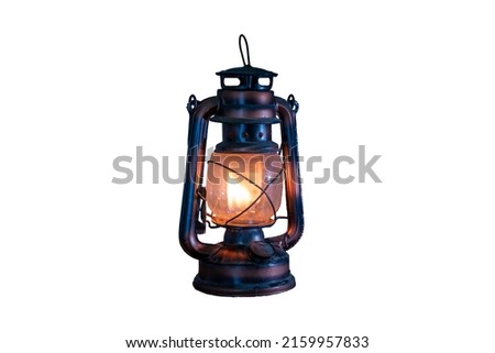 antique kerosene lamp with lights on a white background. soft focus.