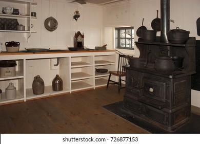 Antique Kitchen With Sink And Cooking Range, Heater, Stove Or Oven With Pots And Pans