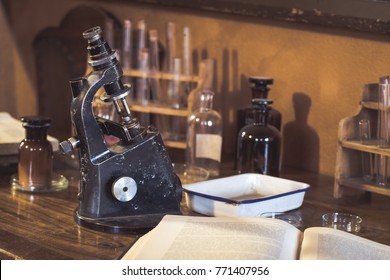 Antique laboratory  microscope and  glassware with selective focus. Science and medical research concept