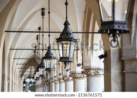 Antique lamps hanging on a walkway in Poland