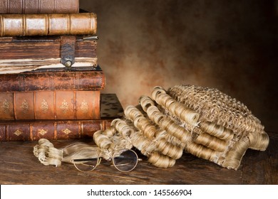 Antique lawyer's wig with old books and glasses