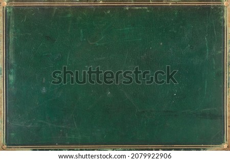 Antique leather-bound book cover with golden border around the edge. Grunge background.