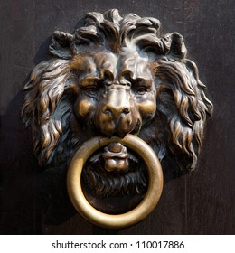 Antique lion's head doorknocker in Aachen, Germany