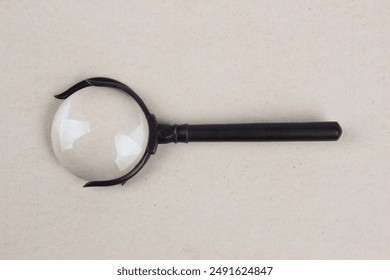 Antique magnifying glass on paper background - Powered by Shutterstock