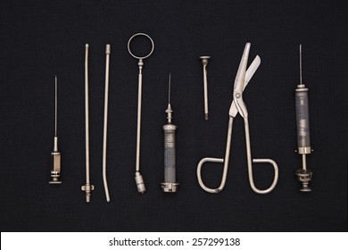 Antique medical tools on a black background