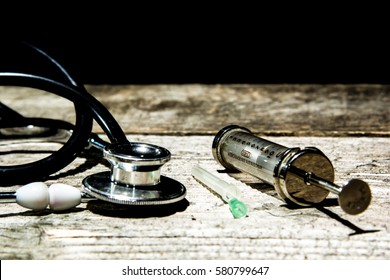 Antique Medical Tools On A Wood Background .