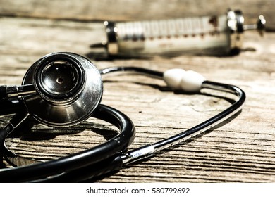 Antique Medical Tools On A Wood Background .