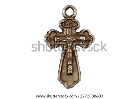 Antique metal cross on a white background. Cross close-up. Religious symbol.