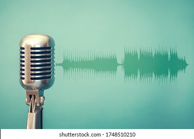 antique microphone on green background and audio waveform