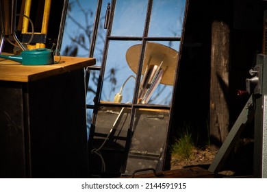 Antique objects are reflecting back from window at vintage market
