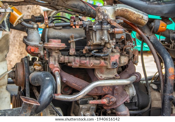 An antique\
old engine block of a Thai TukTuk\
taxi