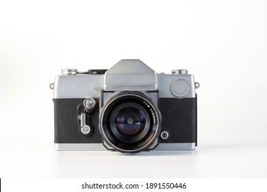 Antique old fashion film camera front view isolated on white background.