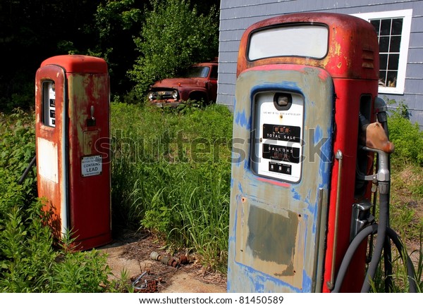 antique pair of gas pumps and\
truck