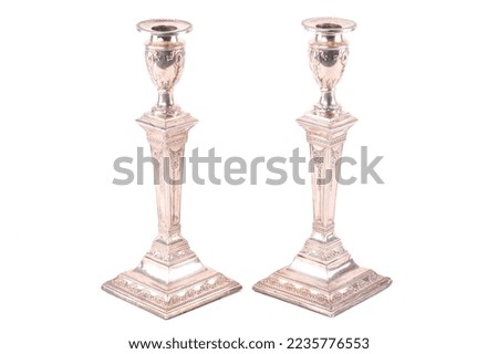 An antique pair of silver candlesticks of column form