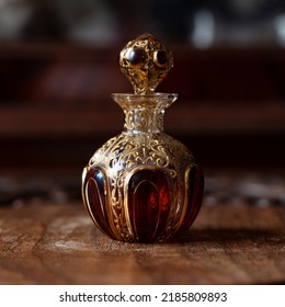antique perfume bottle in luxury interior. crystal bottle with a golden pattern. bohemian glass closeup
					