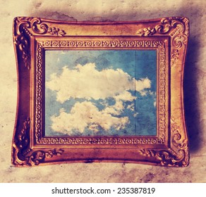 an antique photo frame with a cloud in it  toned with a retro vintage instagram filter effect 