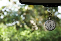 Antique Pocket Watch Hanging From Mirror Showing Five Oclock
