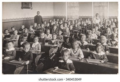 Antique Portrait Of School Classmates. Group Of Children And Teachers. Vintage Picture With Original Film Grain And Blur