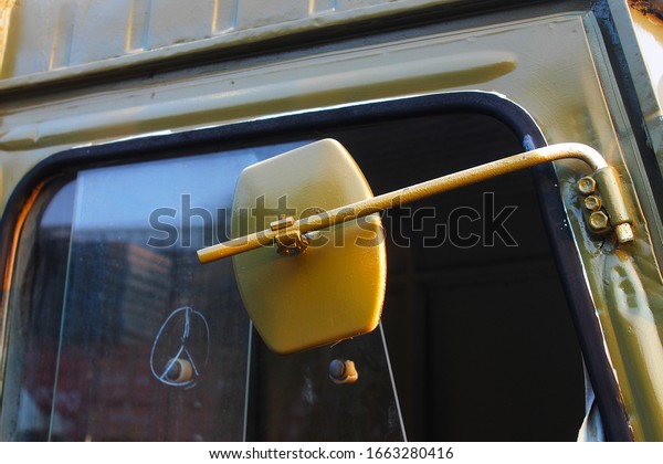 An antique rear view mirror on the right side of the\
old car