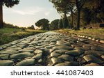 Antique road , Via Appia Antica in Rome, Italy on sunset