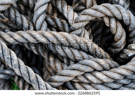 Antique rope made from natural materials. Fragment of a braided cord of large diameter. Close-up