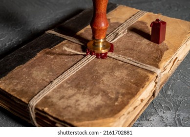 Antique Shabby Book Tied With A Thread With A Wax Seal And A Stamp. The Concept Of Secret Knowledge