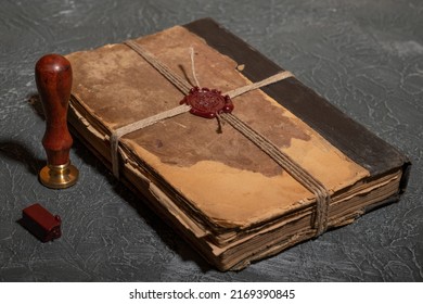 Antique Shabby Book Tied With A Thread With A Wax Seal And A Stamp. The Concept Of Secret Knowledge