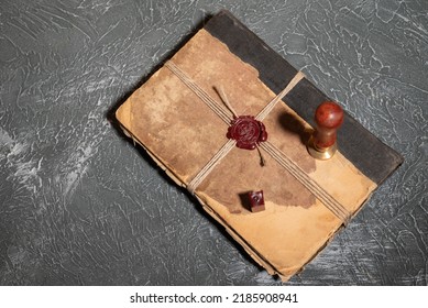 Antique Shabby Book Tied With A Thread With A Wax Seal And A Stamp. The Concept Of Secret Knowledge