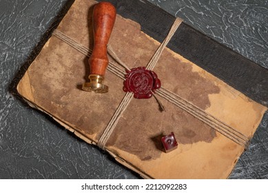 Antique Shabby Book Tied With A Thread With A Wax Seal And A Stamp. The Concept Of Secret Knowledge