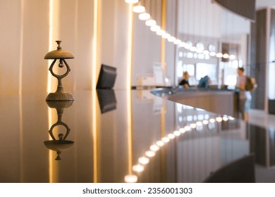 Antique silver front desk call bell on reception counter. Modern luxury hotel desk in pastel beige color background. - Powered by Shutterstock