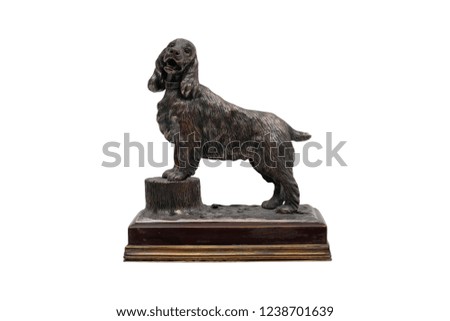 Antique Silver Statuette Dog on a stone stand on a white background. Isolated.
