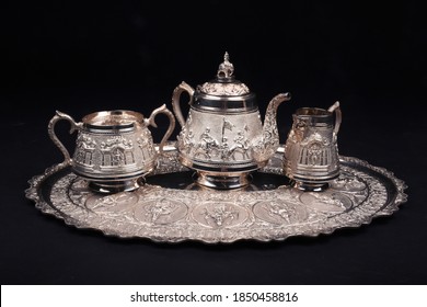 An antique silver tea set presented on a black background - Shutterstock ID 1850458816