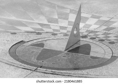 Antique Solar Calendar With A Metal Triangle Pointer In A Granite Scale. Black And White Photo