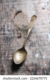 Antique Spoon On A Weathered Wooden Table