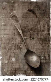 Antique Spoon On A Weathered Wooden Table