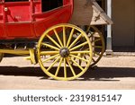Antique stage coach pulled by a pair of horses on a dirt road