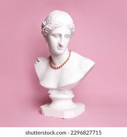 Antique statue bust of pretty woman in red beautiful necklace against pink background. Femininity. Concept of creativity, modernity and vintage, antique art. Inspiration and imagination - Powered by Shutterstock