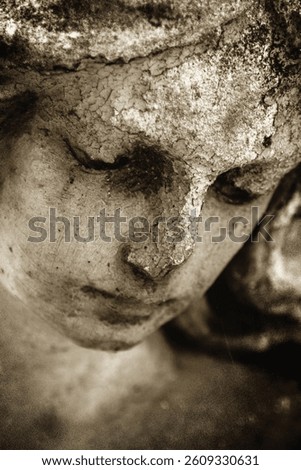 Antique statue of gold angel in the sunlight. Religion, faith, death, resurrection, eternity concept. Vertical image.