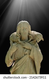 Antique Statue Of Jesus Christ Good Shepherd In The Rays Of Light. In The Christian Tradition, A Symbol Of Human Importance To God.