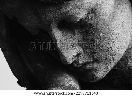 Antique statue of the Virgin Mary praying (religion, faith, holy) Black and white horizontal image.